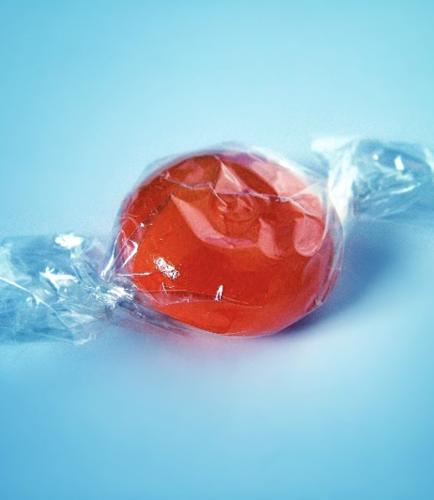 Red candy in plastic wrapper
