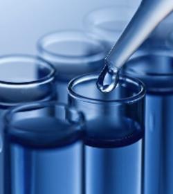 Set of test beakers with a syringe placing liquid into them