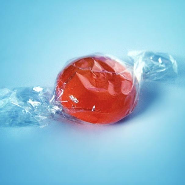 Red candy in plastic wrapper
